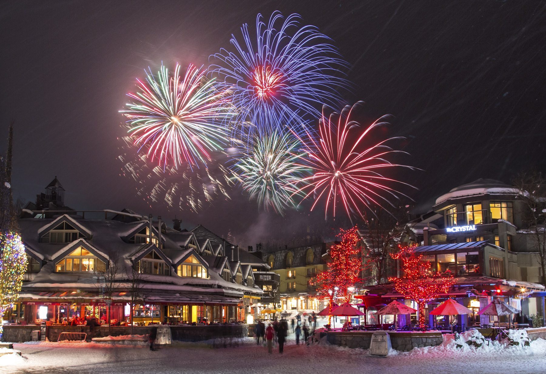 Fireworks over snowy Whistler Village showing mineral-based firework colors