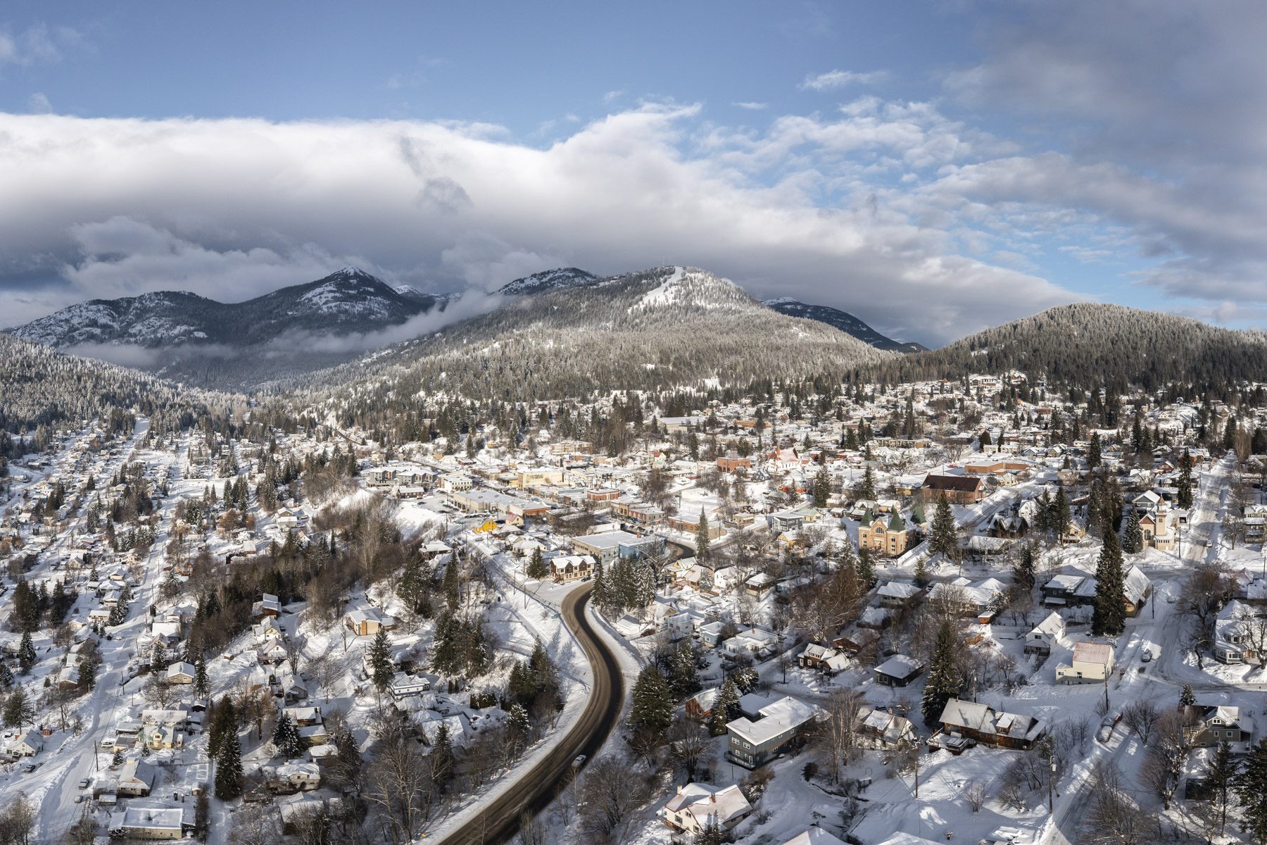Aerial view of snowy Rossland, BC, with Red Mountain rising behind the town